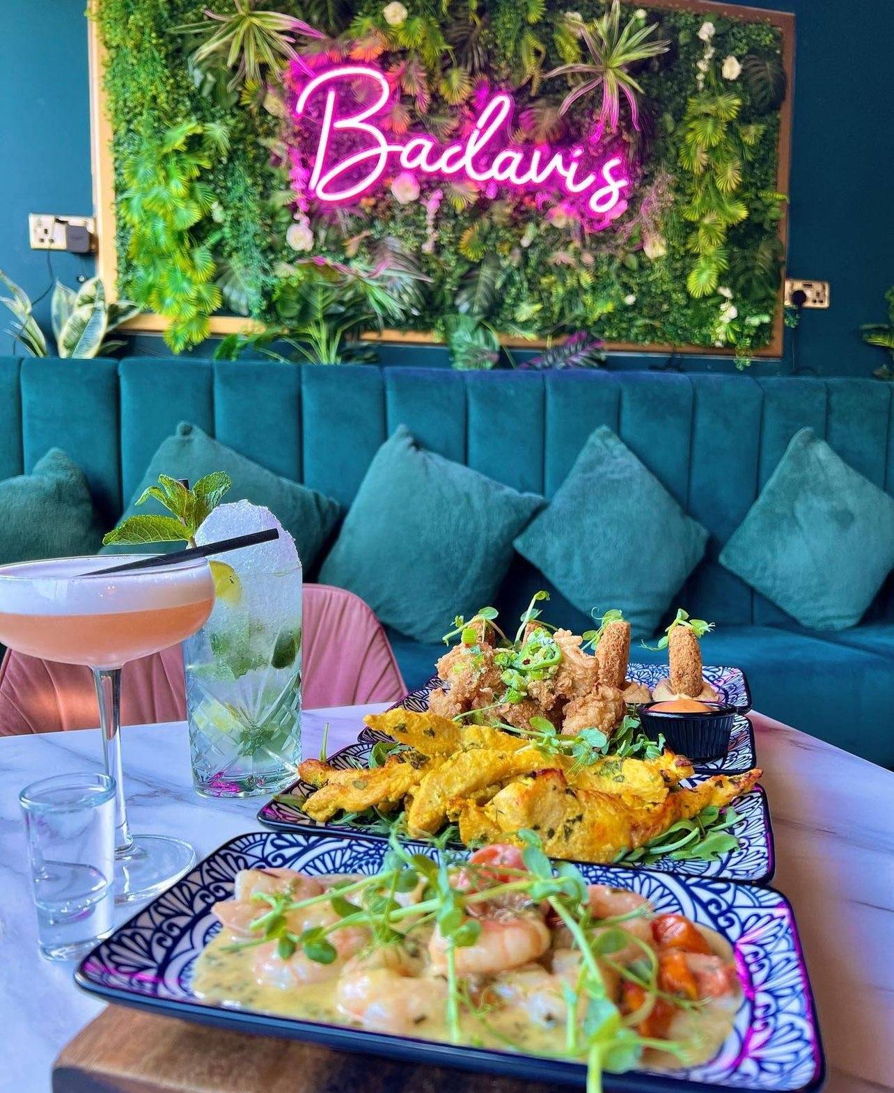 Tapas and cocktails beside the neon Badavi’s sign and teal lounge seating